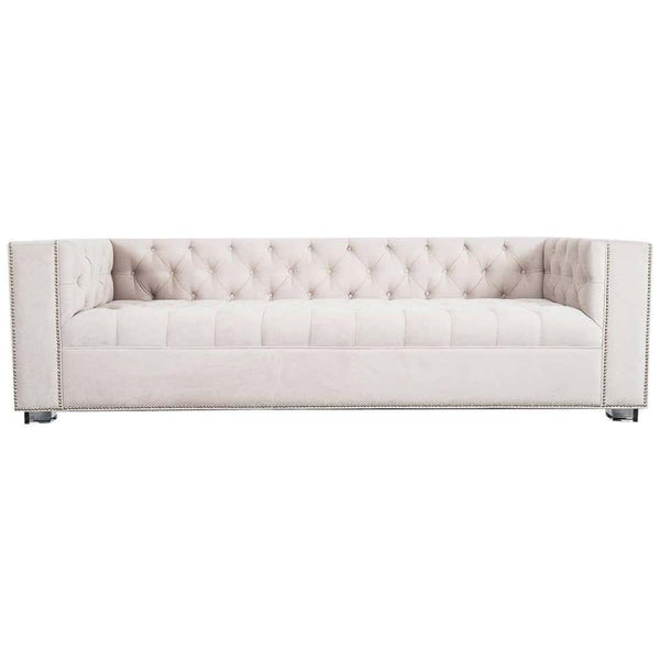 A beige Chesterfield sofa with luxurious tufting, block arm shape, and steel block legs, upholstered in fabric with a nailhead detail finish.