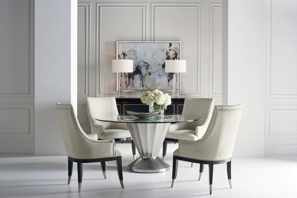 Transitional dining room with upholstered chairs and modern dining table
